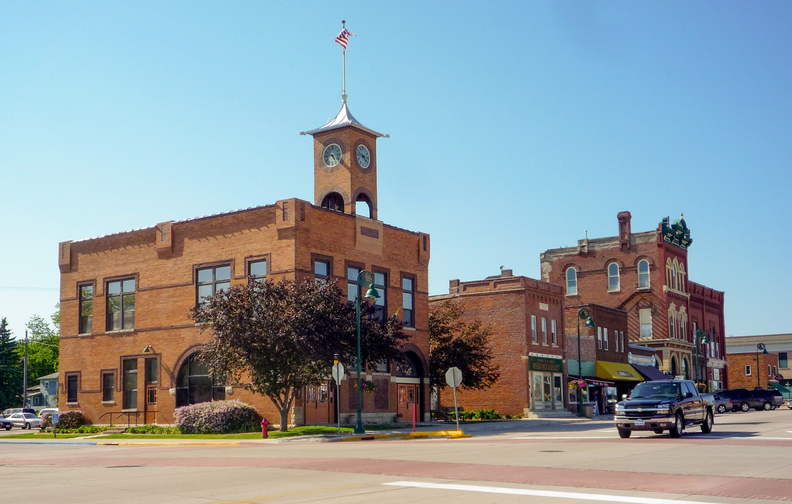 A photo of downtown Pine Island, Minnesota. City Hall is visible in the foreground.